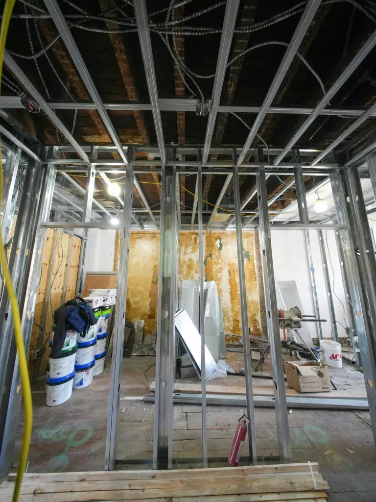 afbouw van een kantoorruimte met een metal stud en kale muren en vloeren.
